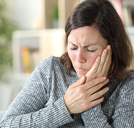 Woman experiencing toothache.